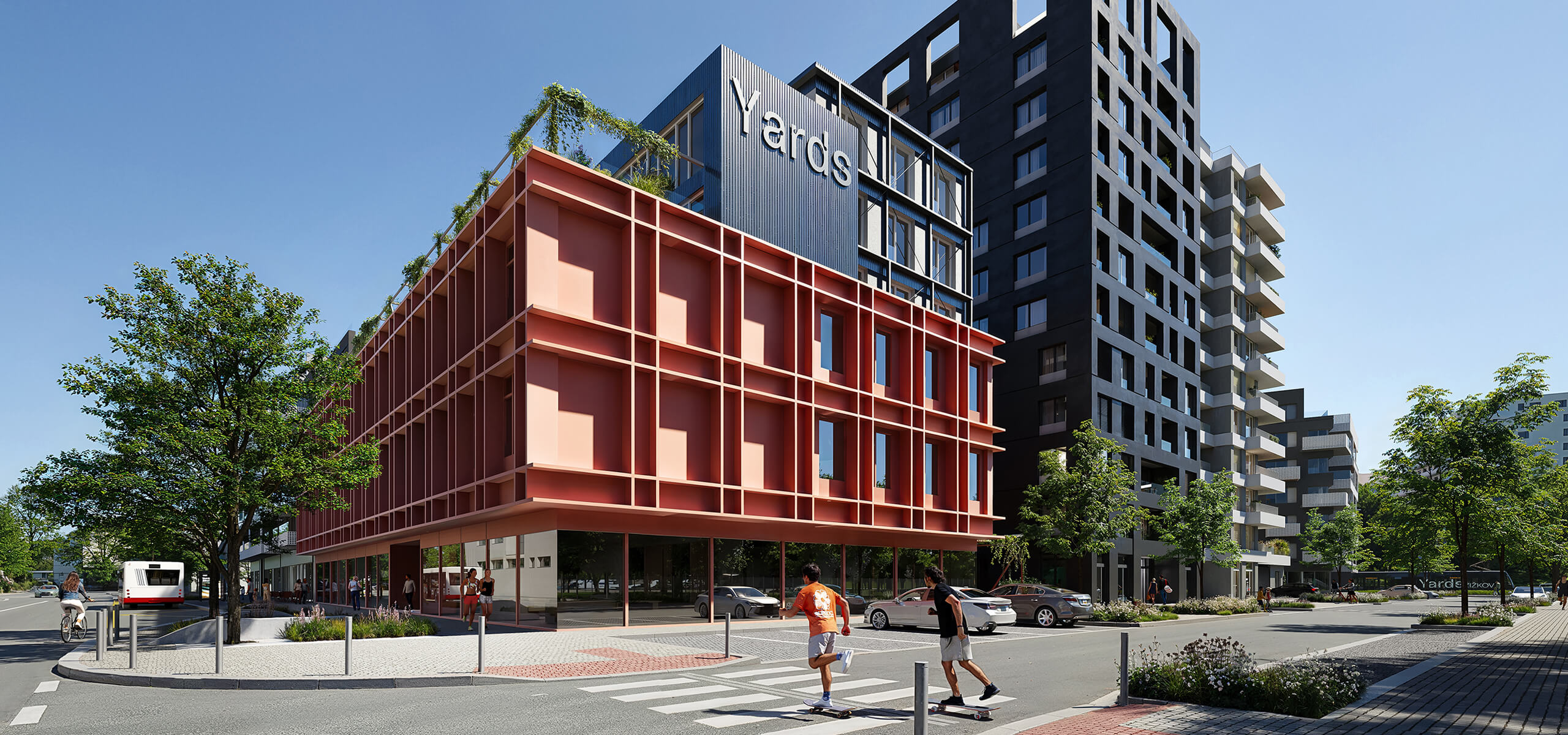 Pohled na moderní budovy projektu Yards Žižkov z ulice s přechodem.